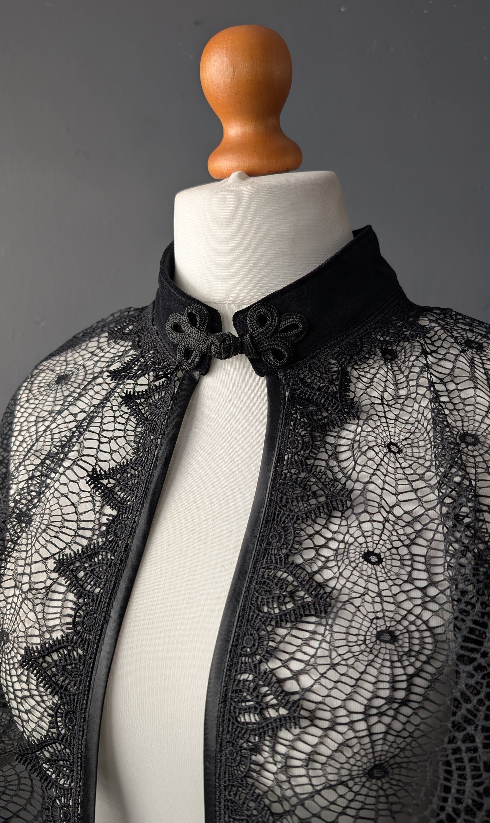 Cape for a gothic bride on a mannequin against a gray background